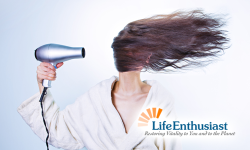 blog, woman with blowdryer blowing hair sideways over her face