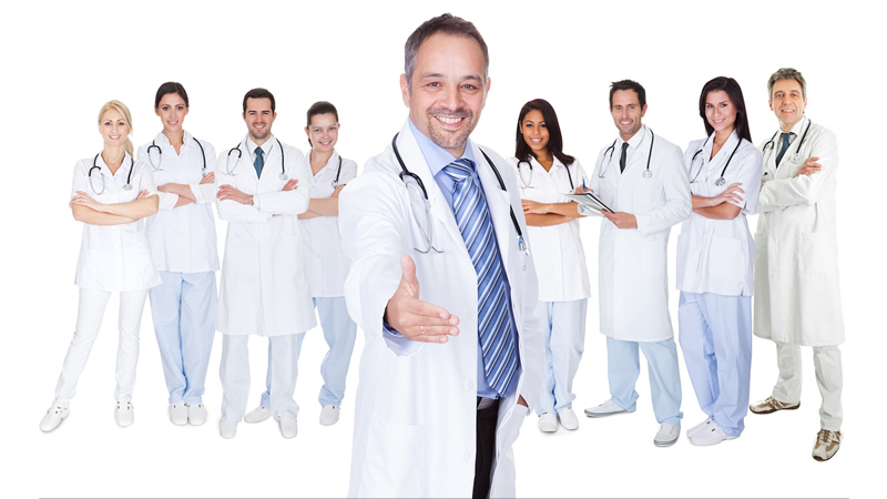 9 smiling doctors with middle mans hand outstretched