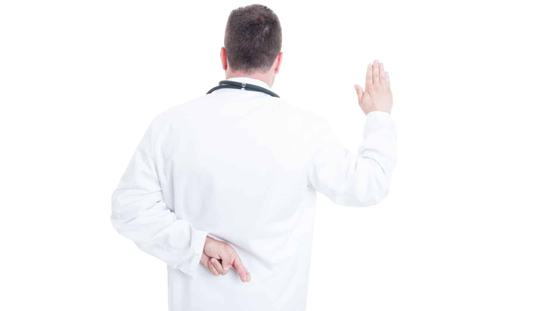 back of doctor in white lab coat, one hand held up to swear the truth, other hand behind his back with fingers crossed