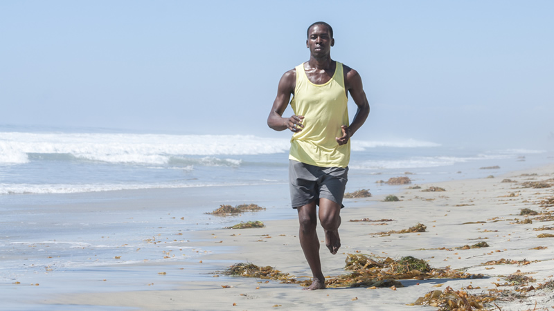 fit man running on beach