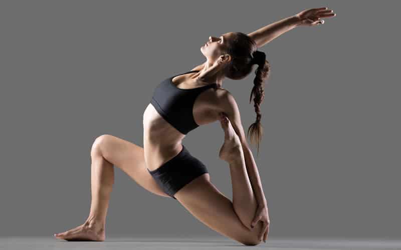 young fit woman in back stretching yoga pose