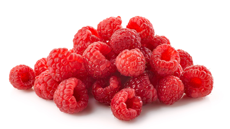 close up small pile of raspberries on white