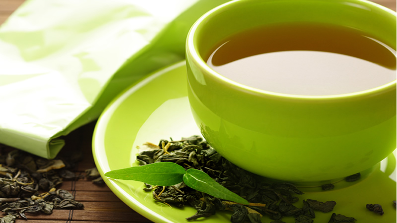 green tea in green mug and saucer
