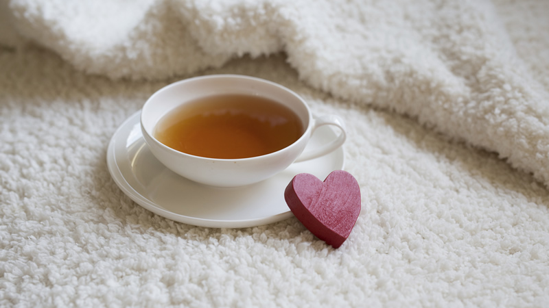 cup and saucer of tea with red heart