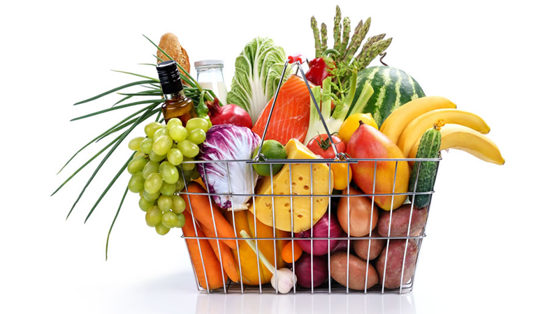 wire basket of fruit, vegetables, cheese and oil