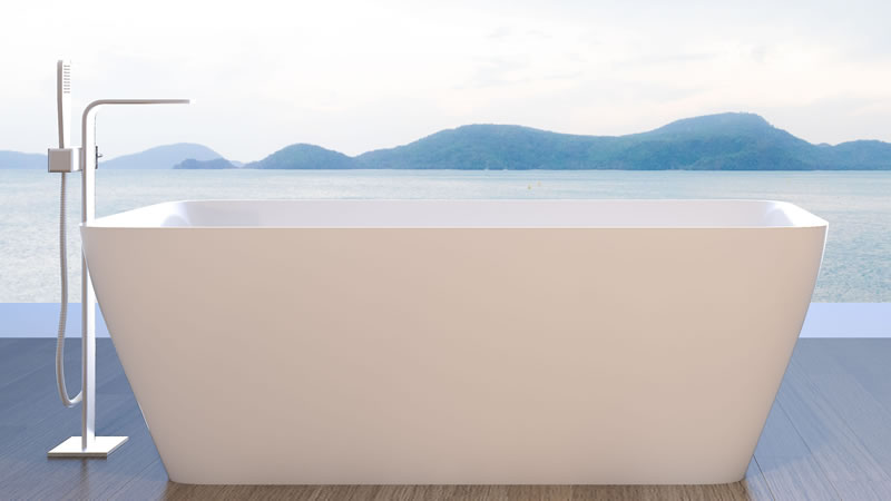 bathtub outside on deck with lake and mountains beyond