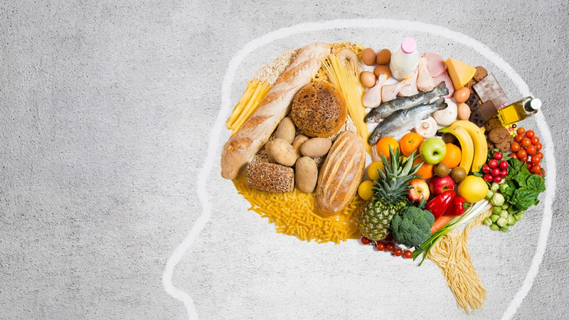 top view of healthy food and grains on outline of head, as if in the brain