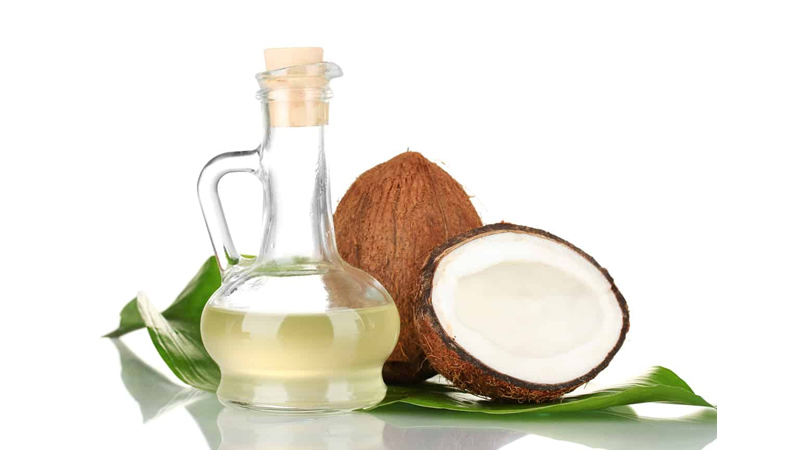 coconut oil in glass jar with whole and split open coconut