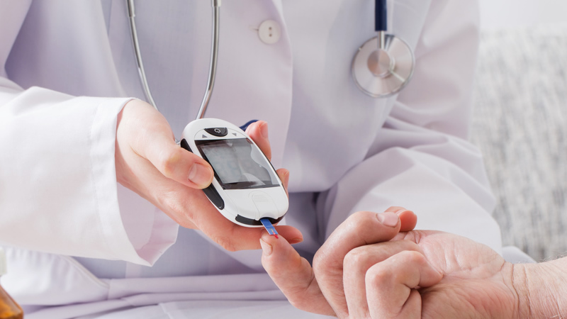 doctor pricking patients finger with diabetes blood sugar test