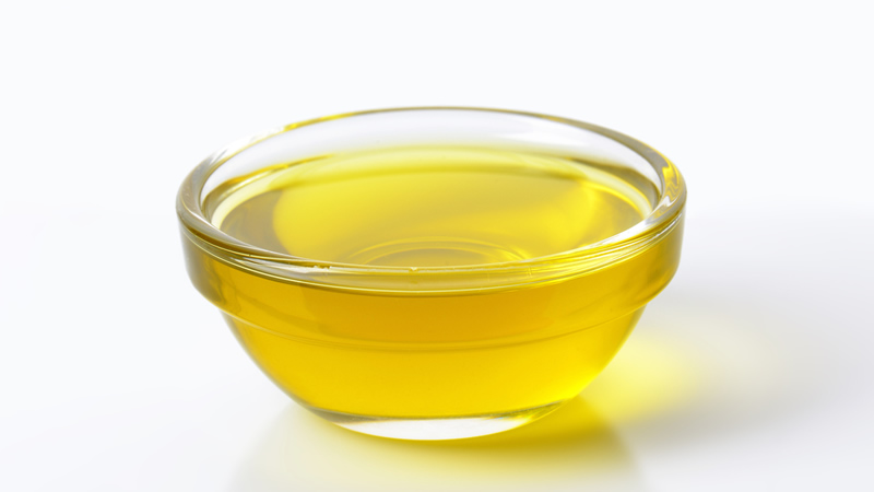 small clear bowl of yellow oil