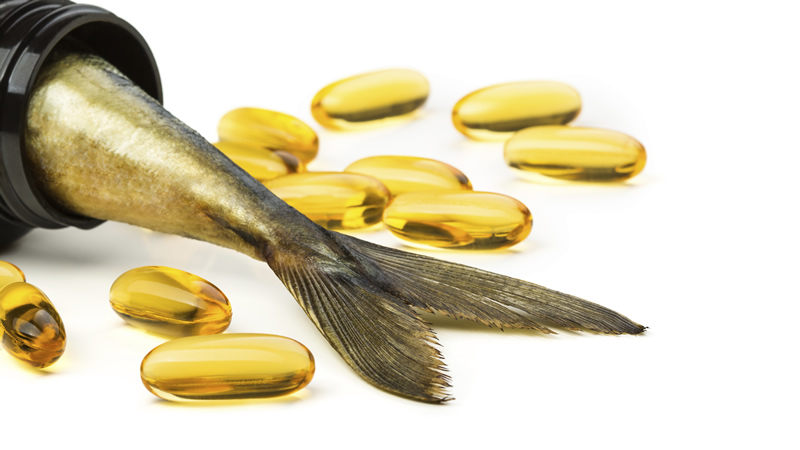 fish oil capsules with fish tail coming out of bottle