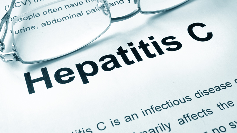 words Hepatits C on paper with glasses
