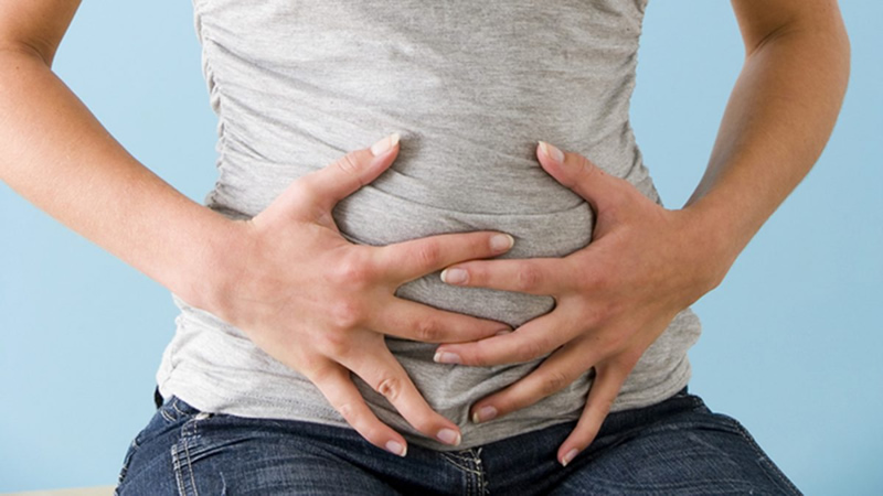 woman with hands spread onto her belly