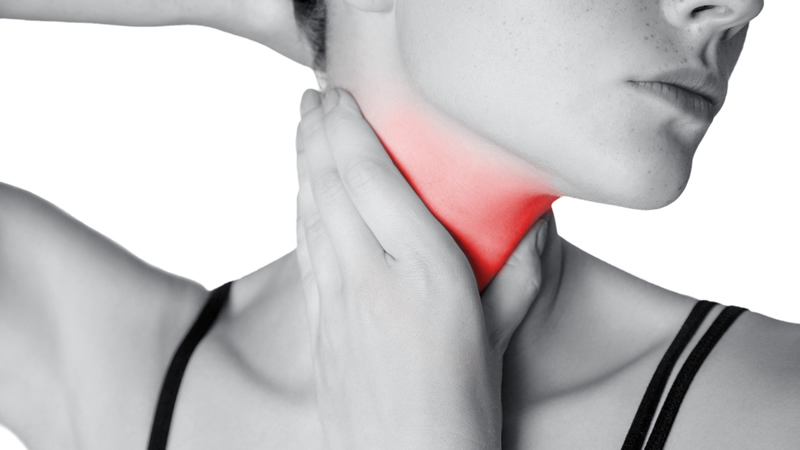 woman holding pain in her neck shown in red