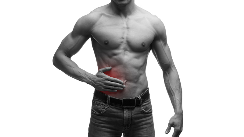 man holding his side with painful red area