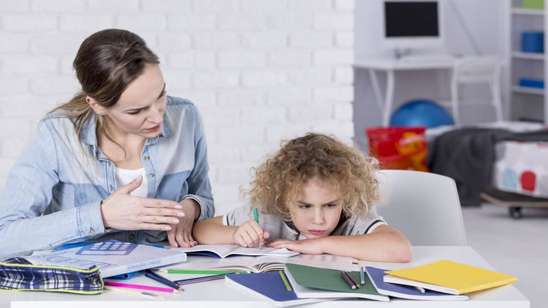 mom trying to help frustrated child with homework