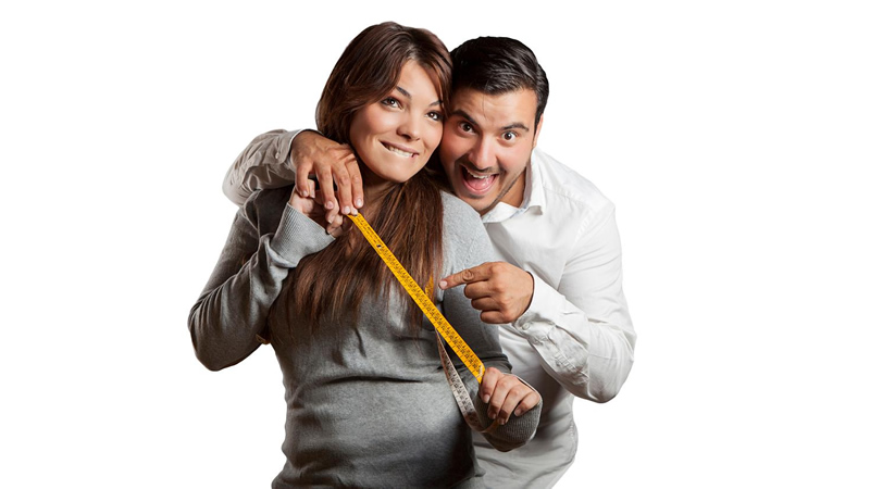 happy woman and man with measuring tape