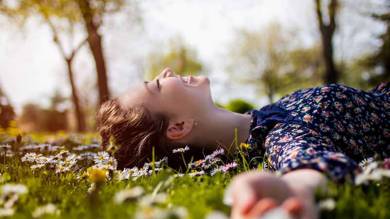 side view smiling woman lying on grass