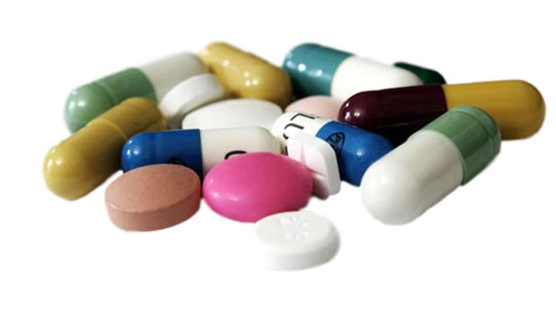 small pile of capsules and tablets on white