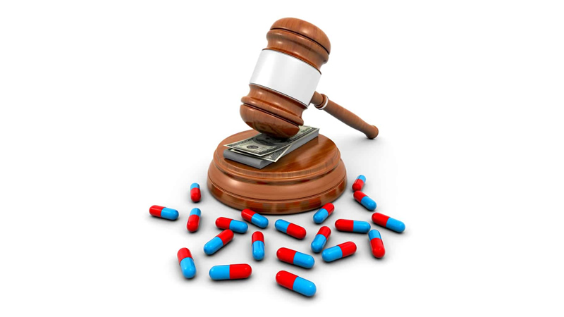 gavel on cash surrounded by pills