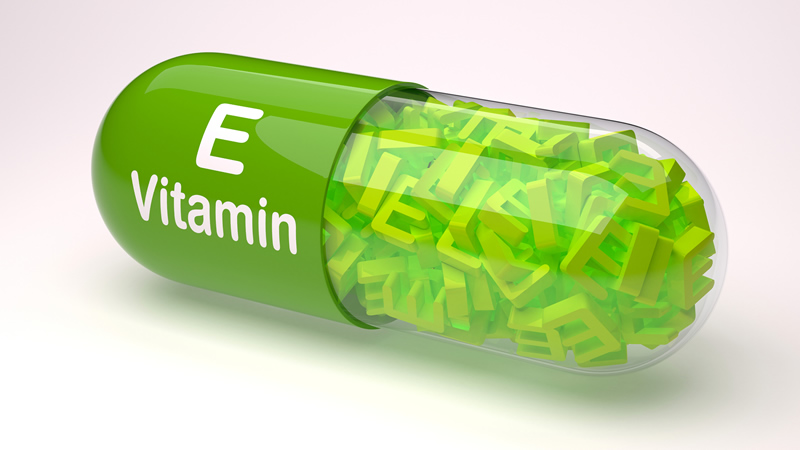 large green capsule E Vitamin containing letters E