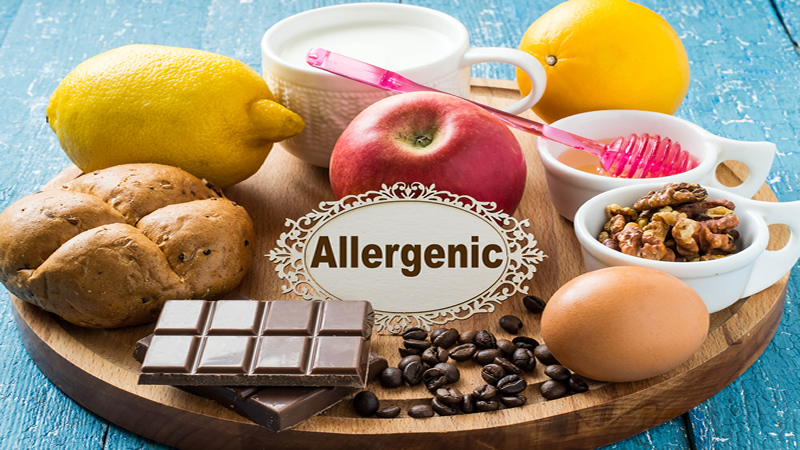 word Allergenic surrounded by chocolate, coffee, bread, egg, honey, milk, apple
