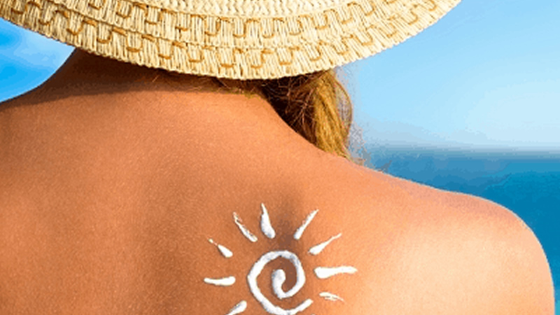 image of sun drawn with sunscreen on womans back