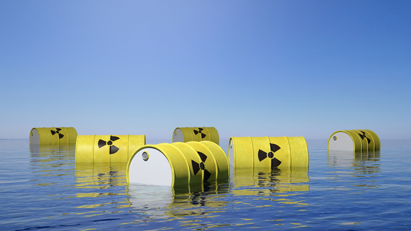 yellow barrels with toxic radiation symbol, floating in ocean