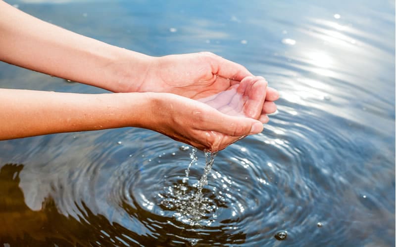 Clear water flowing through cupped hands